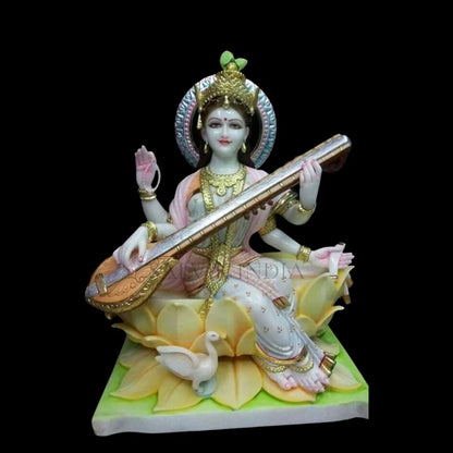 Painted marble Saraswati idol sitting on lotus with Veena artwork