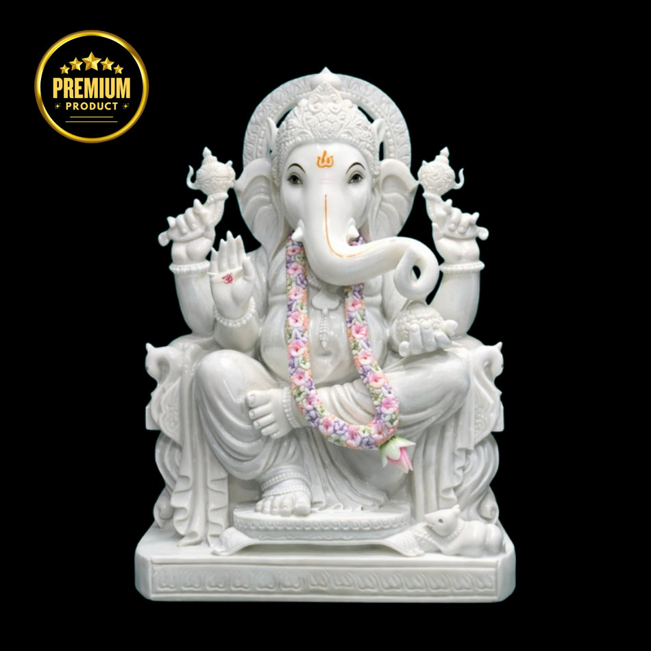 White marble Ganesh statue handcrafted from Makrana marble in sitting posture.
