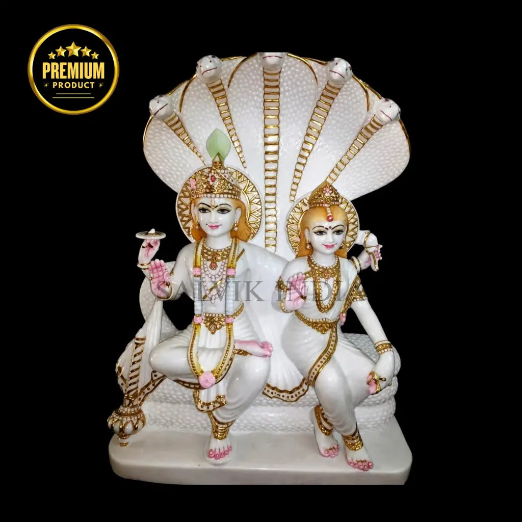 White marble Laxmi Narayan idol featuring Lord Vishnu and Goddess Lakshmi seated together